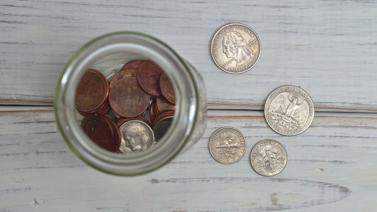 Glass jar filled with coins representing retirement savings